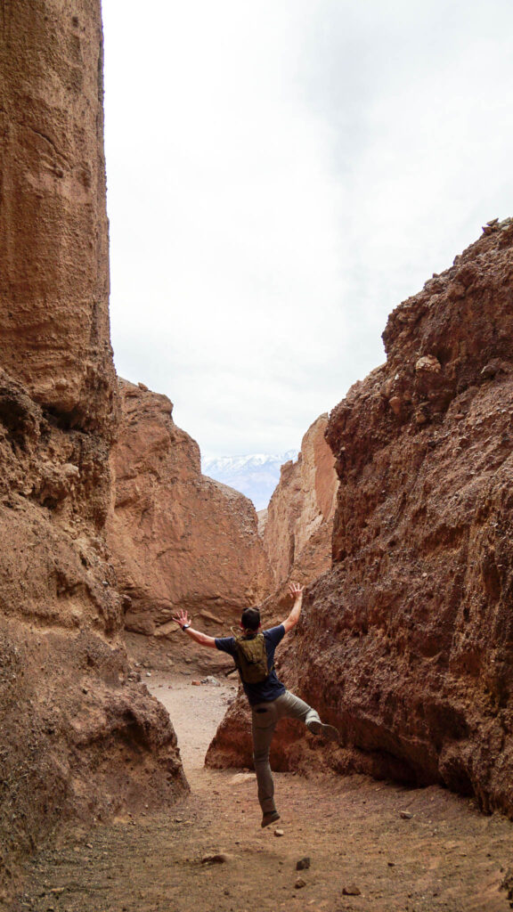Alex having fun by the dry waterfall near Natural Bridge in Death Valley