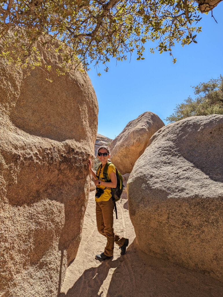 Me in between the two boulders serving as gates to Hidden Valley Nature Trail in Joshua Tree National Park