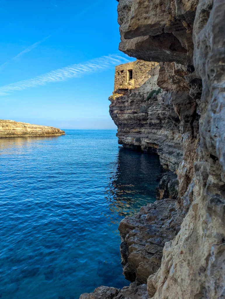 Caves, rocks and the blues of the sea by Lama Monachile Beach - one of the best places to visit in Polignano a Mare